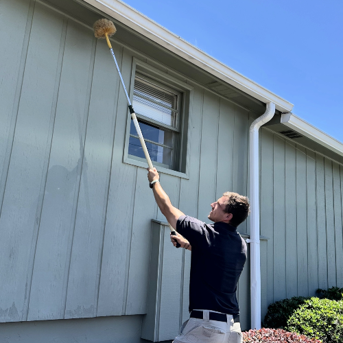 Pest Control Tech Treating Exterior